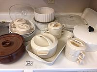 Full overview of all serving dishes including casseroles, bean pot, small bowls, and the large pot with lid.