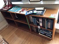 Full front and top view of teak bookcase with some books and items on top and inside shelves, showing size and condition.