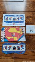 Photo shows the full sheet of Superman stamps and two Day of Issue envelopes with comic-style Superman artwork and stamps.