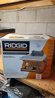 Front three-quarter view of sealed Ridgid EB4424 box showing brand name, product rendering and model information.
