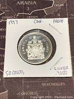 Obverse of 1997 Canadian 50 cents silver proof coin showing coat of arms and details.