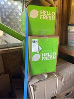 Boxes labeled with Hello Fresh stacked on top of each other along with another cardboard box underneath