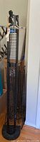 Four metal CD racks shown standing vertically, tallest rack is measured at 63 inches
