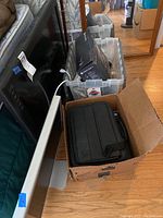 Apple monitor with silver aluminum stand and power cable showing ports on back.
