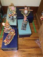 Overview of six PenDelfin collectible figurines displayed on blue and green boxes arranged on a wooden floor.