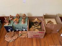 Full lot displaying all PenDelfin houses on their respective boxes, large house, wishing well, and accessory pieces in cardboard boxes.