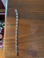 Full view of the sterling silver bracelet showing heart-shaped links and clasp.