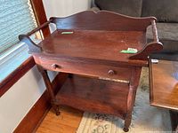 Front angle showing wash stand with drawer, towel racks, and scratches