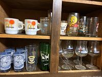 Photo showing all glasses including McDonald's mugs, character glasses, blue patterned glasses, green glass, and stemware glasses.