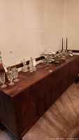 Full side view of mid-century modern buffet with items on top illustrating length and design.