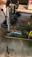 Photo of Craftsman drill press metal body with crank handle, on concrete floor