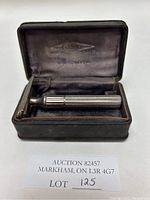 Open black velvet-lined original case with visible Gillette branding and silver metal vintage razor inside.