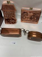 All four items displayed together showing two plaques and two pots on a white background.