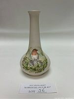 Front view showing detailed bird design and gold trim on the vase