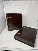 Two Bombay wood storage boxes shown side by side, closed, with visible brass hinges and dark polished wood finish.