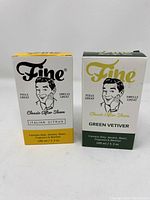 Two boxed bottles of Fine Classic After Shave side by side showing front labels for Italian Citrus and Green Vetiver.