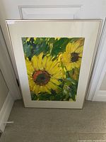 Full view of framed sunflower painting with two large yellow sunflowers and green leaves in background.