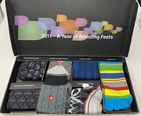 Closeup on one box's sock designs, showing diverse patterns including a sneaker, stripes, and argyle.