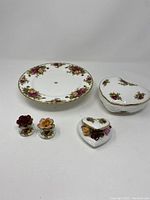 Full lot showing salt and pepper shakers, heart-shaped trinket box, and decorative plate