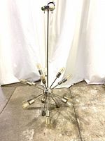 Full view of the Sputnik style chandelier with 18 light bulbs radiating from the chrome steel center sphere, showing the bulbs and structure from above.