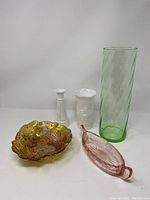 Photo of all five glass items: two milk glass vases, green uranium glass vase, amber carnival glass bowl, pink dish.