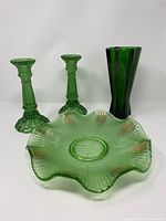 Green glassware set featuring Anchor Hocking rocket vase, pair of candleholders, and footed plate