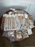 Full lot overview showing 18 quartz stone point necklaces on gold chains, multiple rainbow beaded bracelets, and 9 DIY bead/string bracelet kits in packages.