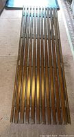 Top view showing the full length of the bench with slat design and walnut wood finish.
