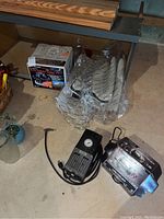 Sears inflator/compressor device with pressure gauge and power cord, plastic wrapped buffer polisher handle next to it