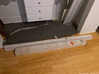 Two long boxes containing door hardware kits placed on floor