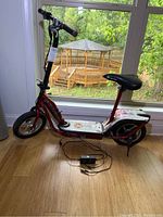 Side view of entire scooter with charger connected