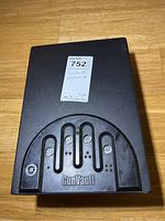 Top front view of GunVault wall safe with biometric lock and keyhole