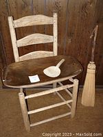 Photo showing the full lot including the old wood chair frame, dough bowl with ladle on it, and the straw broom standing upright.