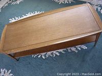 Top-down view showing rectangular wood tabletop with some water stains and wear.