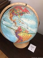World globe showing Americas, part of Atlantic Ocean, with detailed country borders and latitude/longitude markings.