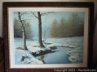 Overall view of framed painting showing winter scene with trees and stream