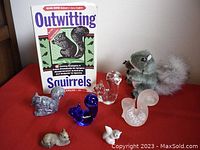 Lot with 3 glass squirrel paperweights, 3 squirrel figurines, finger puppet and book with upright cover