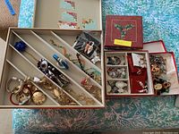 Five trays displaying assorted Halloween and Christmas themed costume jewelry including necklaces, earrings, brooches and bracelets