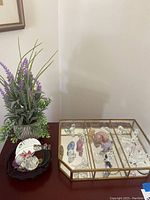 Overview of display case, faux lavender plant, and decorative tray on table