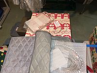 Photo of clear glass serving trays and small round dishes on top of a quilted padded surface.
