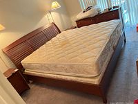 Angled full view showing headboard, side rails, mattress on frame