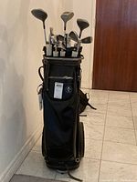 Full view of the black Atlantic golf bag loaded with golf clubs, showing condition and accessories inside.