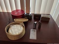 Full lot arranged on table showing trinket boxes, lighters, readers with case, and makeup/perfume sets.