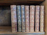 Seven leather-bound Rudyard Kipling books with titles visible on spines in Danish language, showing age-related wear.