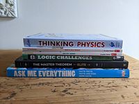 Photo showing spines of six books stacked horizontally, titles visible