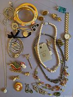 Full lot of costume jewelry laid out on flat surface