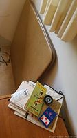 Angle showing foldable card table surface and assorted bridge game items piled on it.