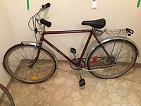 Side view of the maroon Free Spirit bike showing frame, wheels, seat, and rear rack.