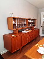 Front view of sideboard and hutch showing glass doors, drawers and cabinets