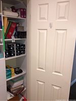 Overview of white shelving with items on shelves